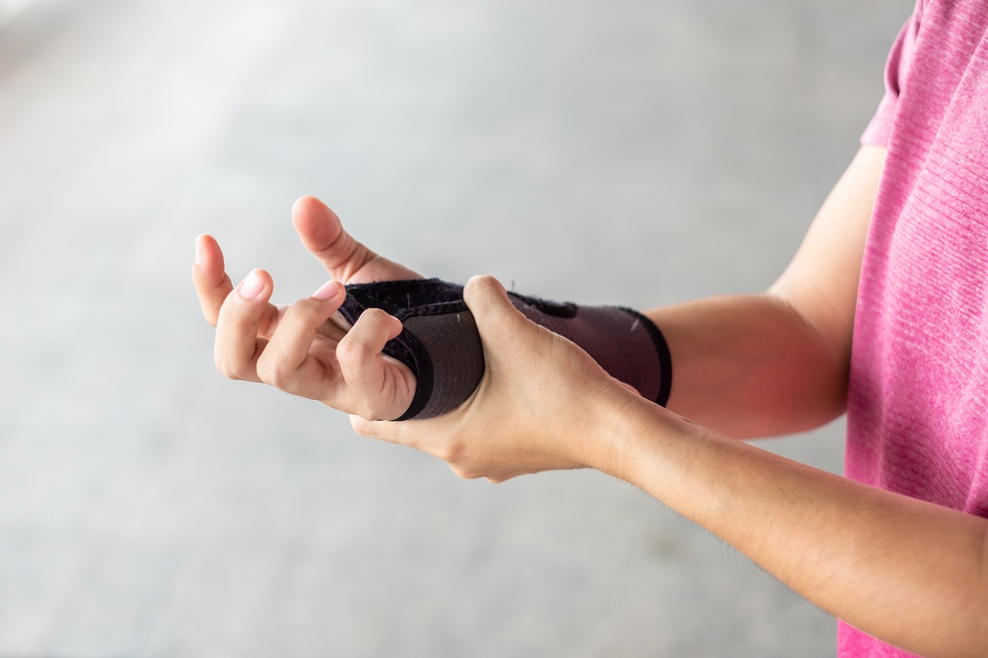 woman holding her wrist pain