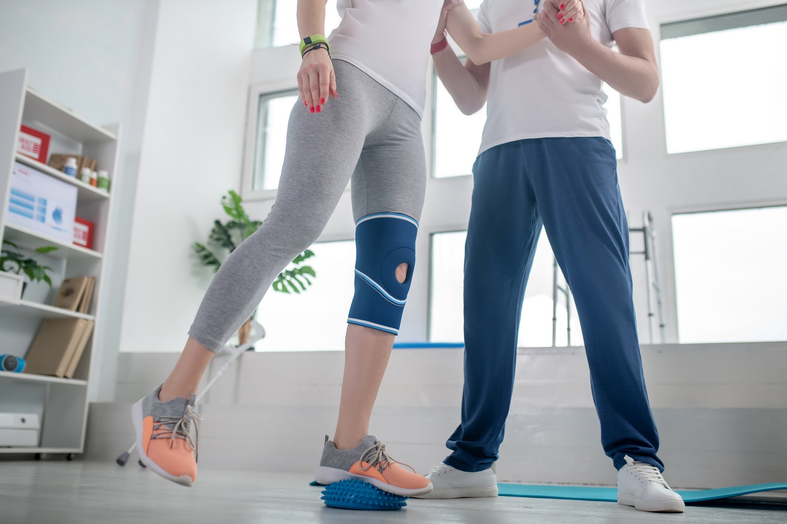 male physiotherapist assisting female