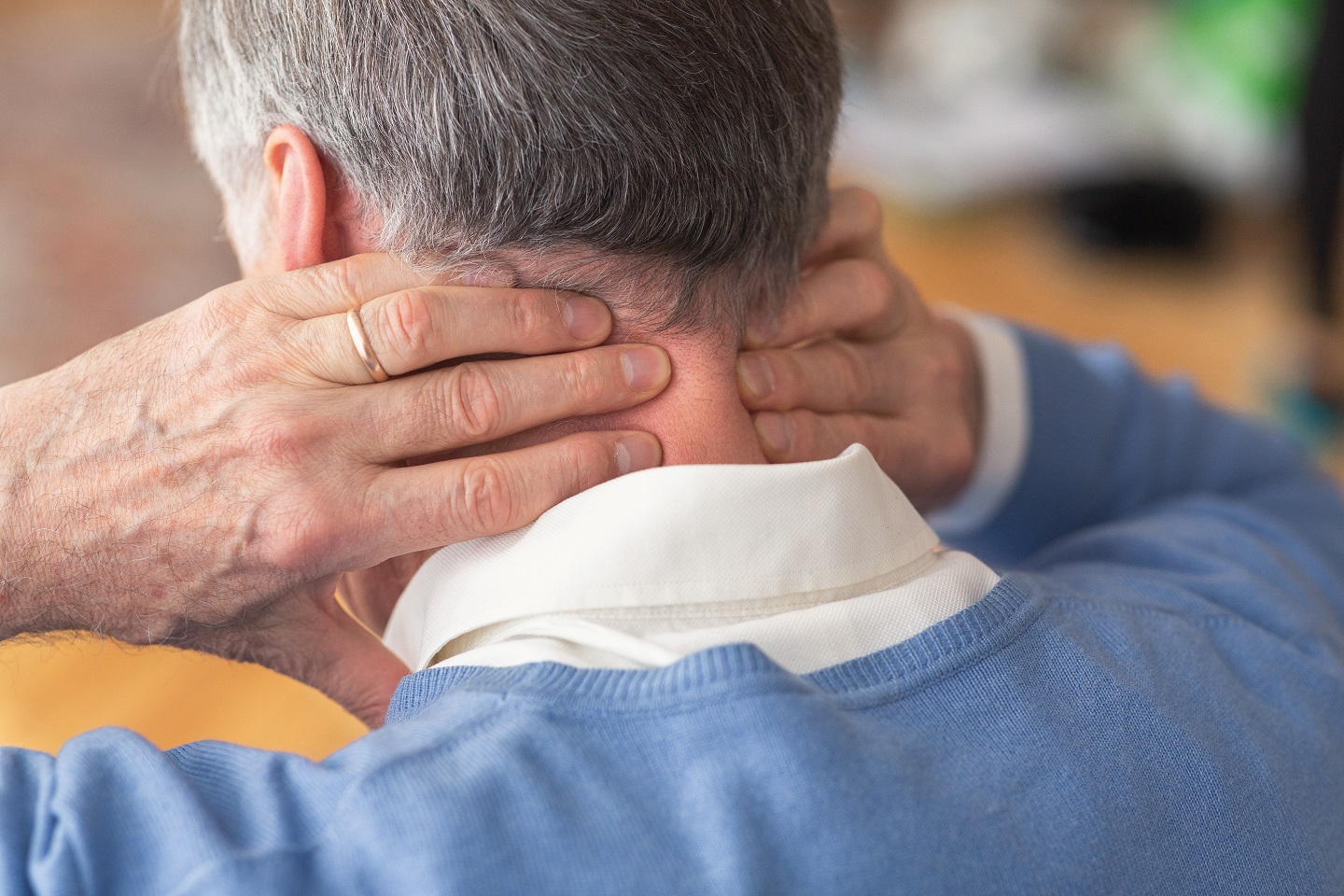 elderly man having neck pain