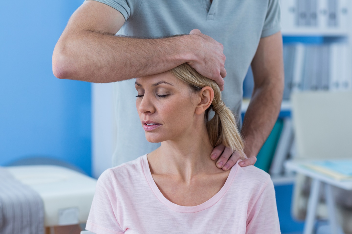 physiotherapist stretching neck of a female patien