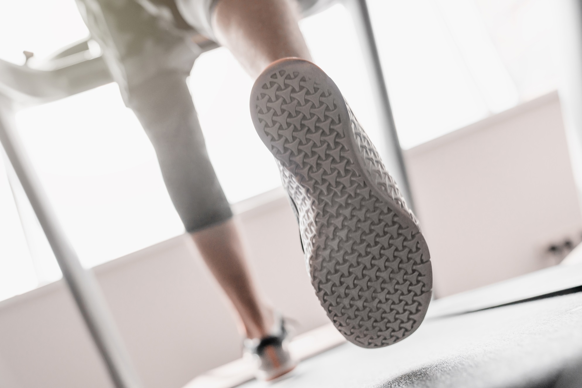 close up of man legs running on treadmill in sport 