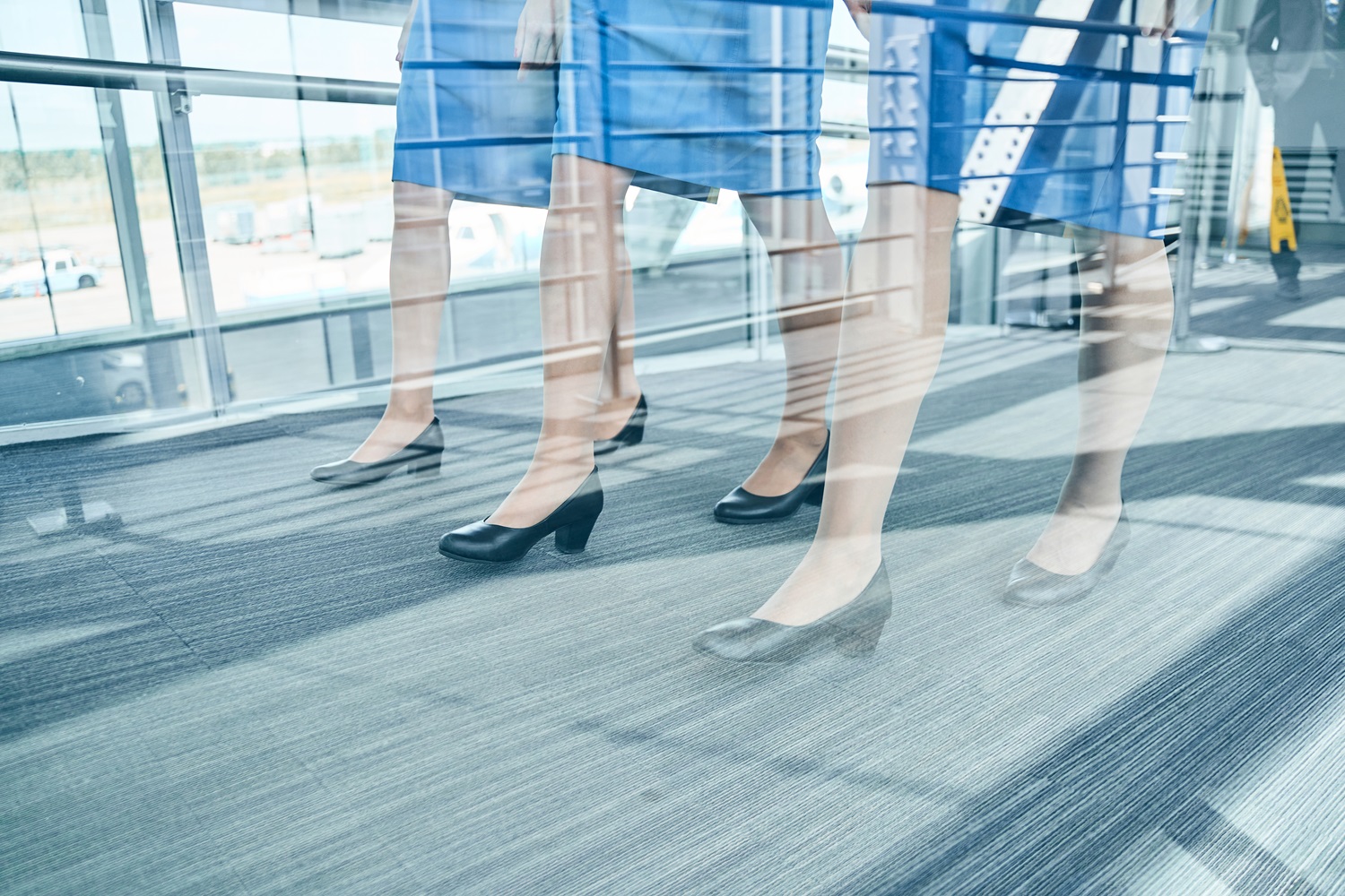 stylish caucasian airline female employees moving