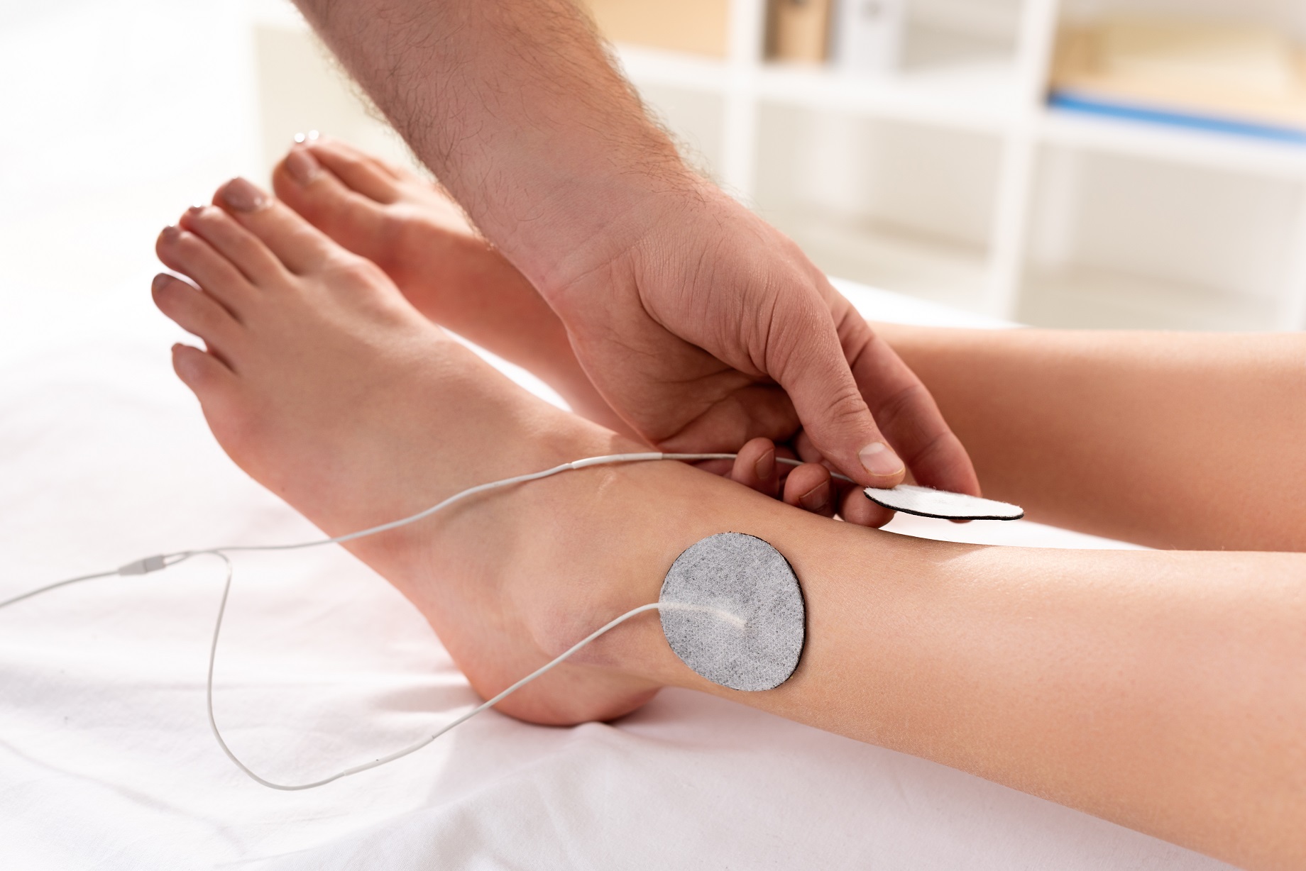 cropped view of doctor holding electrode