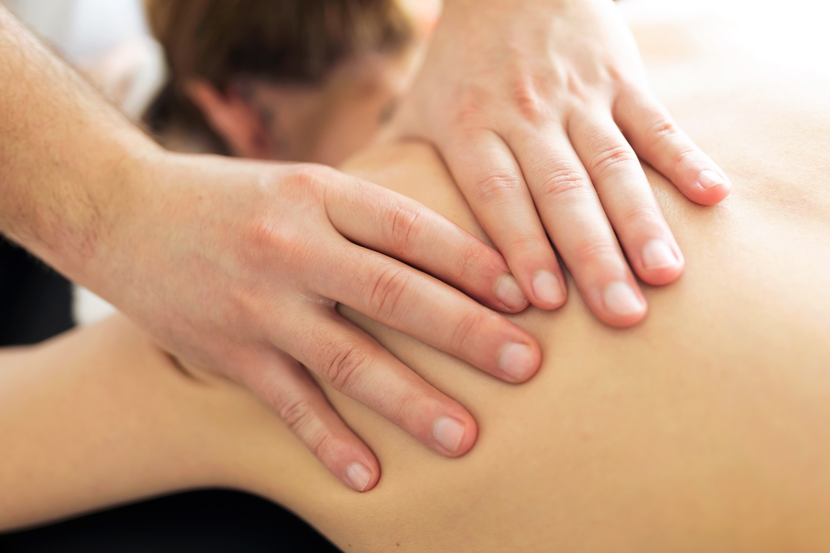 young physiotherapist doing a back treatment