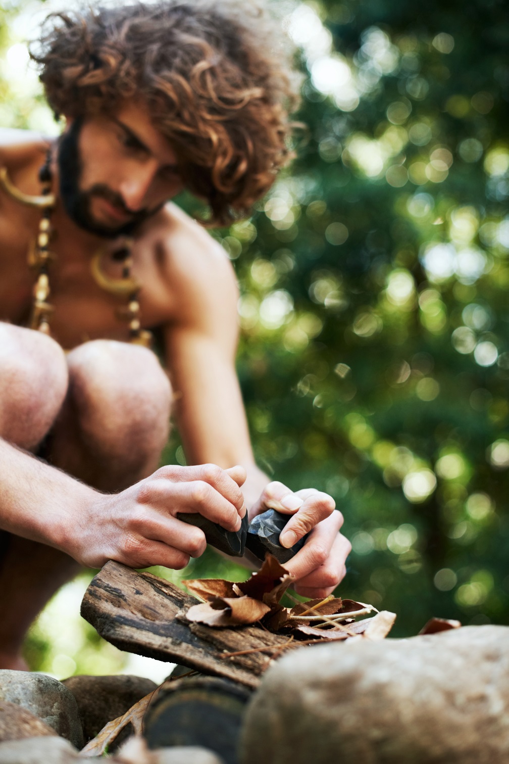 creating fire a young caveman trying to create fi