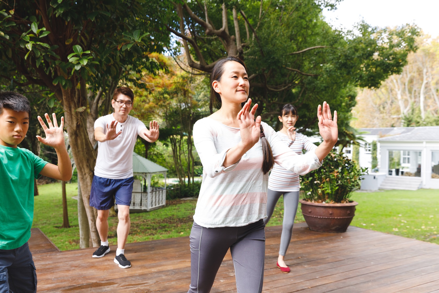 happy asian parents son and daughter exercising