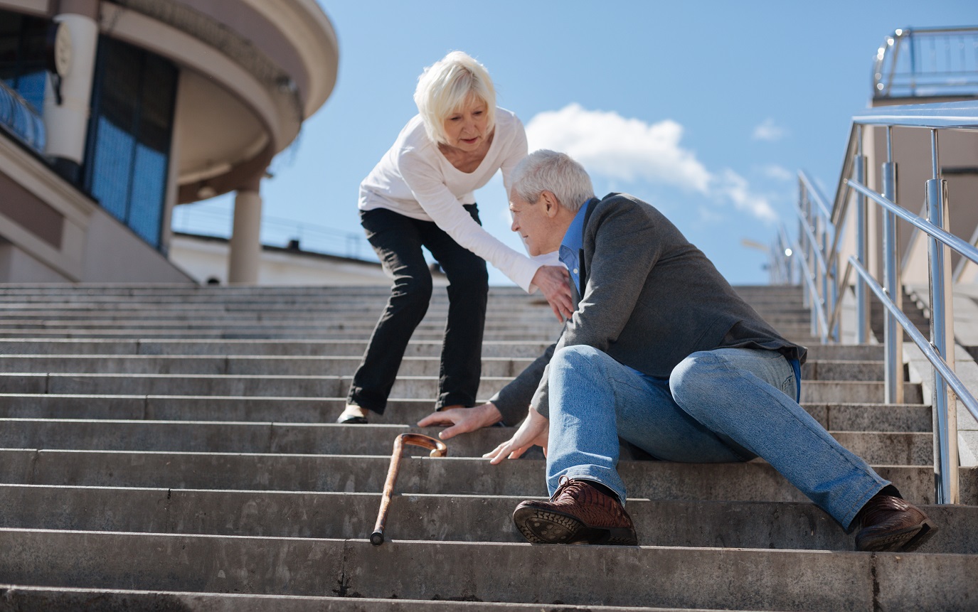 white haired frustrated concerned pensioner sitting street having dizzy