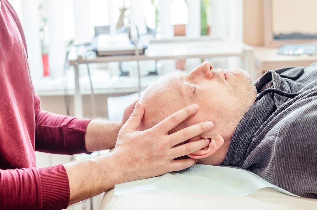 male patient receiving cranial sacral therapy