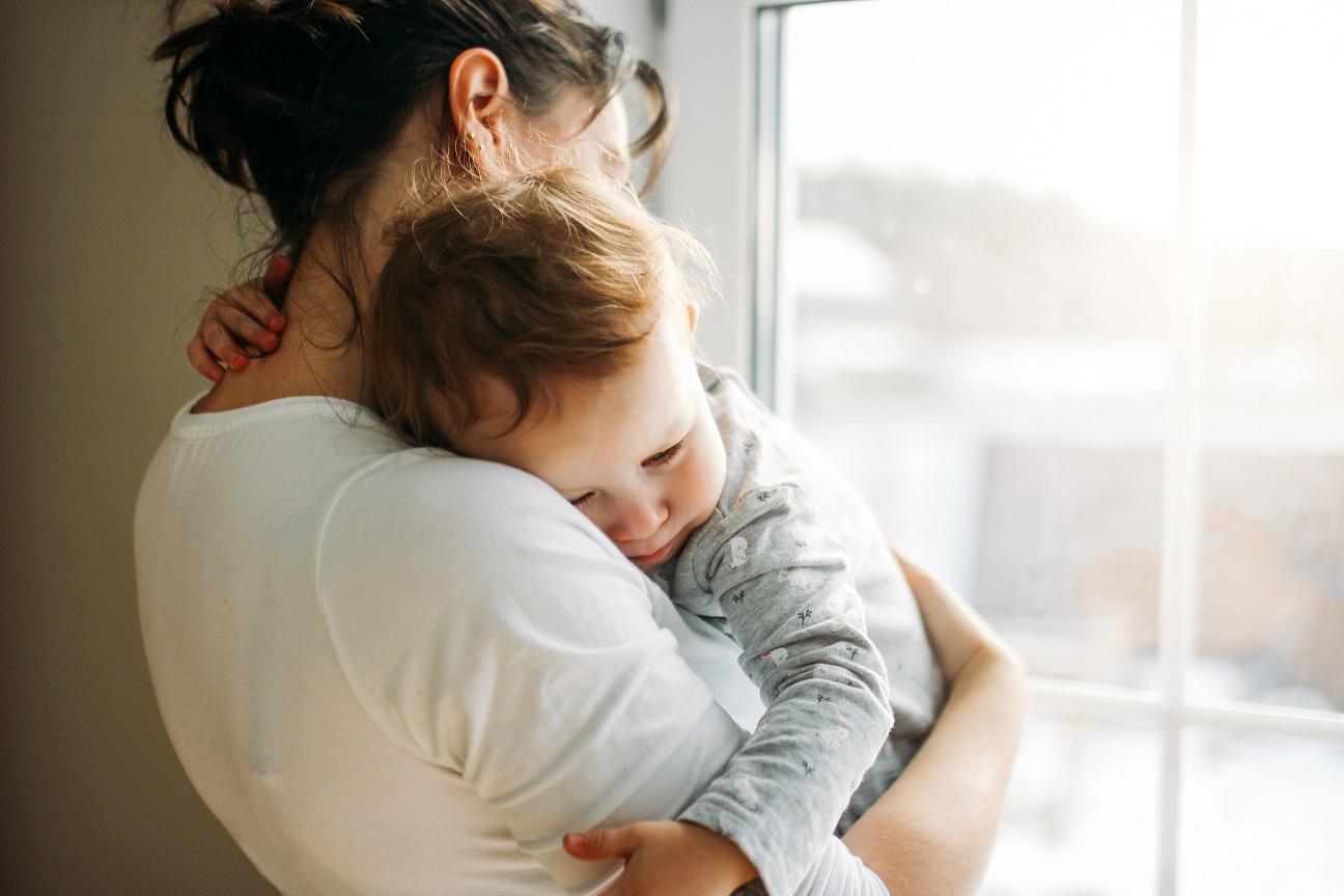 young woman with baby girl at home