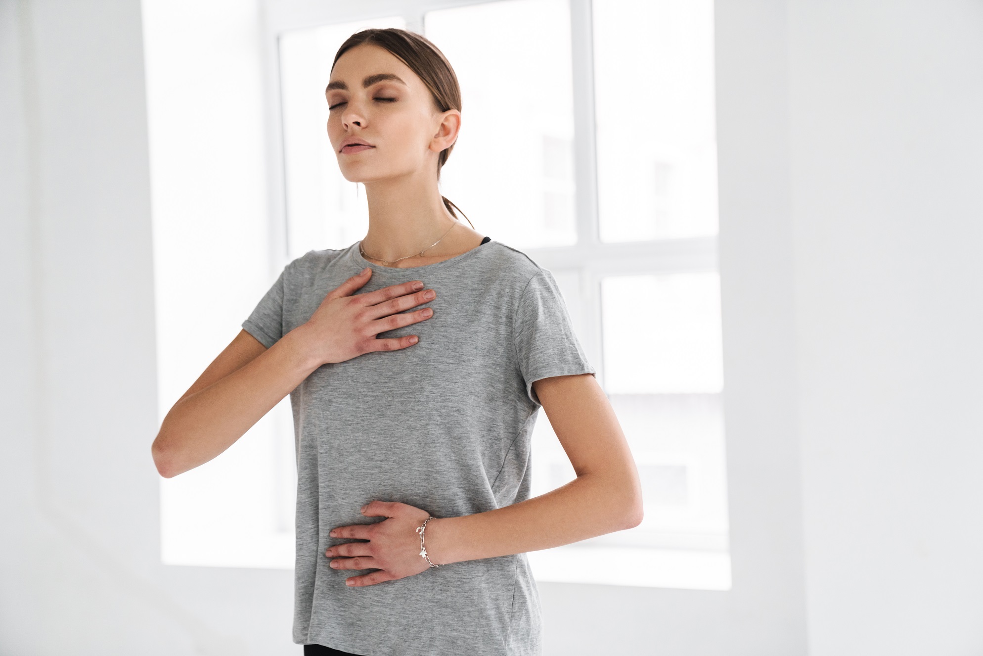athletic sportswoman doing breathing exercise
