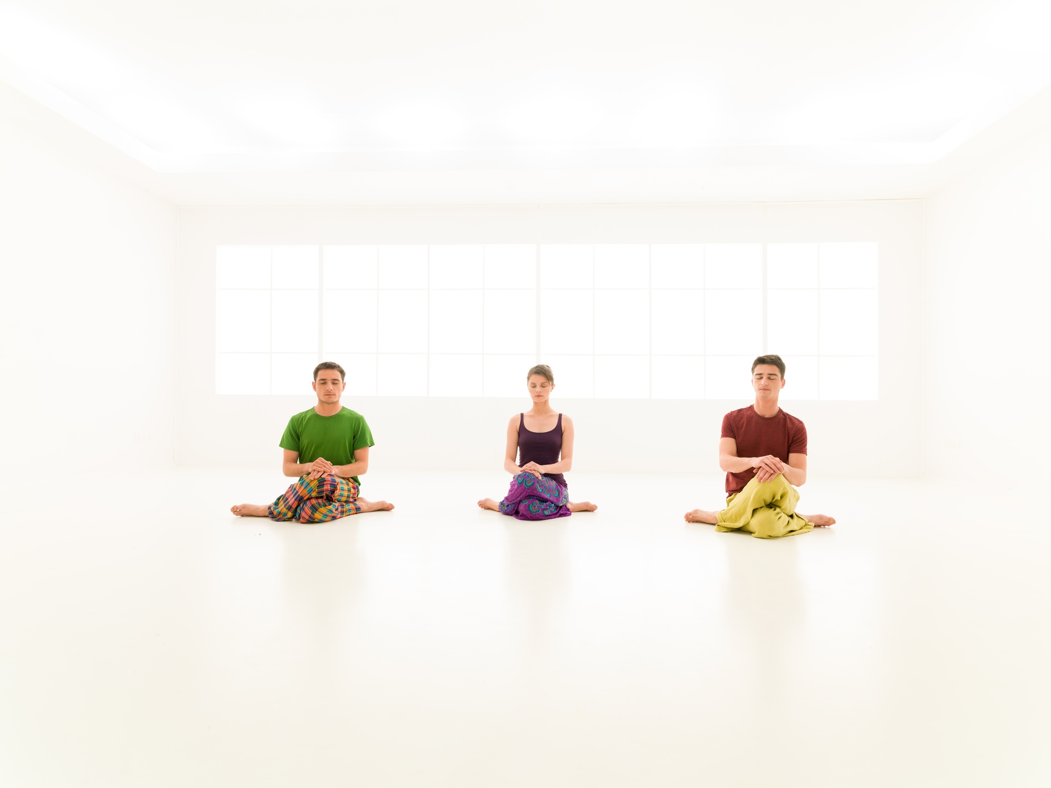 three casual people yoga class