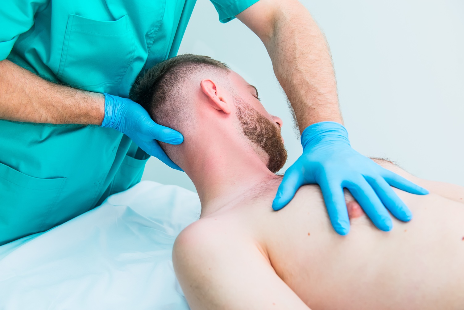 a chiropractor stretching his patient s neck