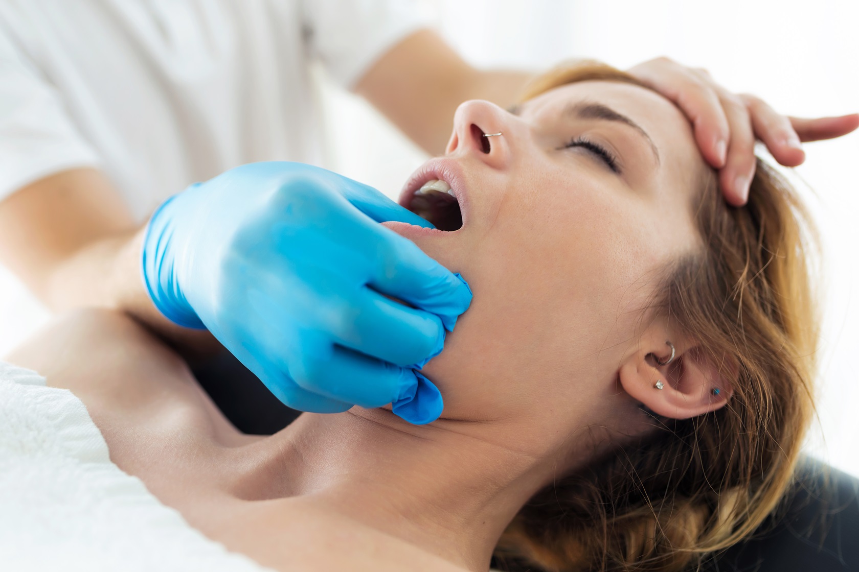 young physiotherapist doing a face treatment