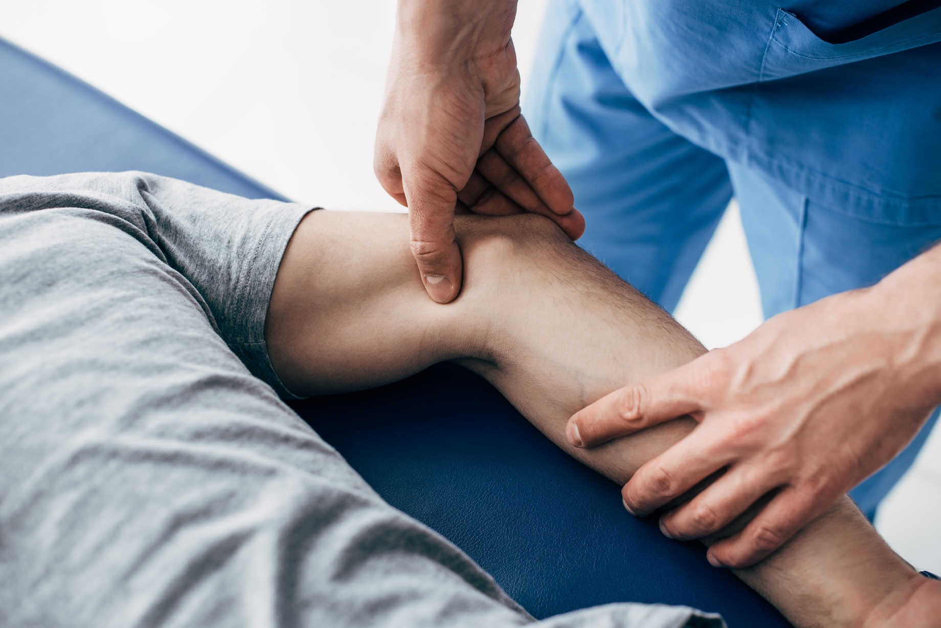 partial view of chiropractor massaging arm of pati